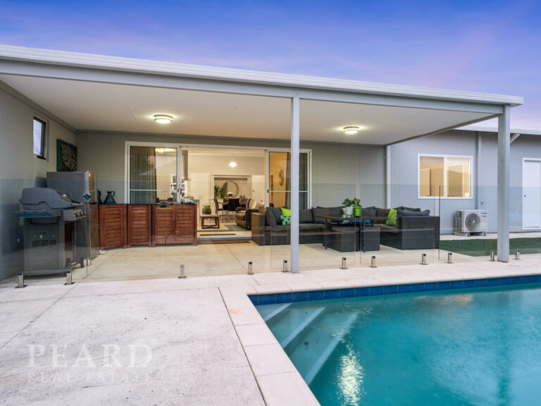 Rear or house with outdoor furniture, swimming pool and roof providing shelter