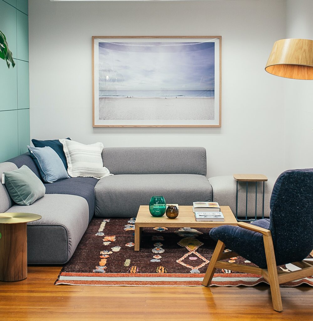 Living area with couch, coffee table chair and painting