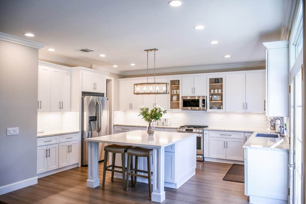 White home kitchen with lights turned on