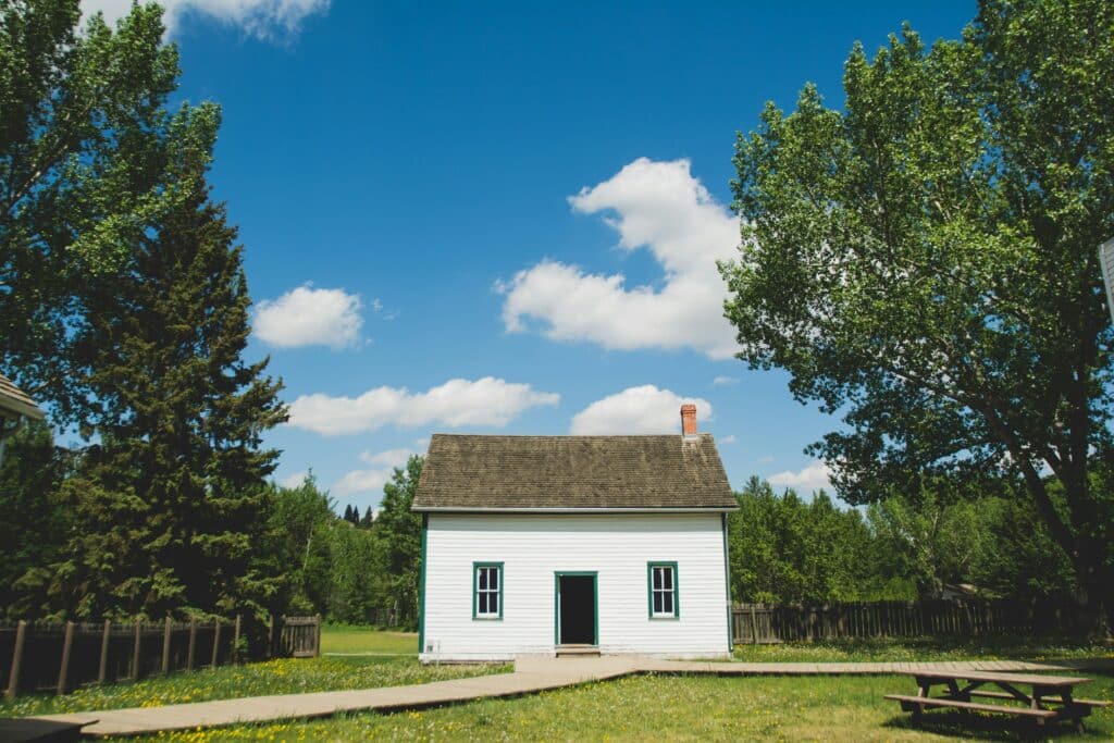 Small white granny flat with chimney. 